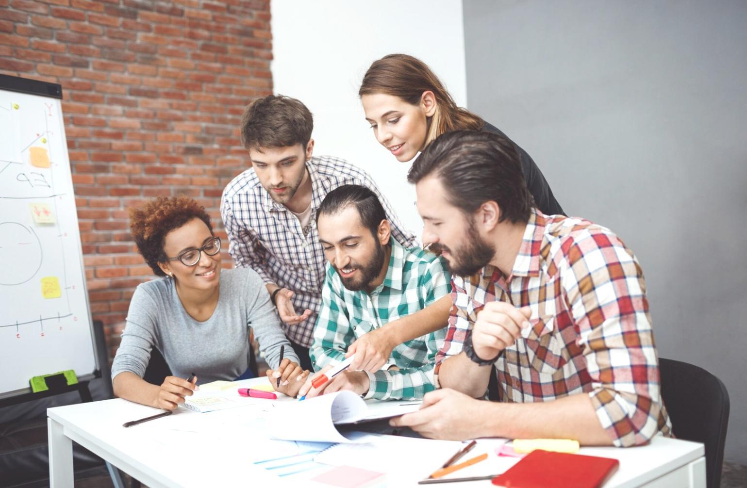 Professional woman analyzing financial data on computer screen with charts
