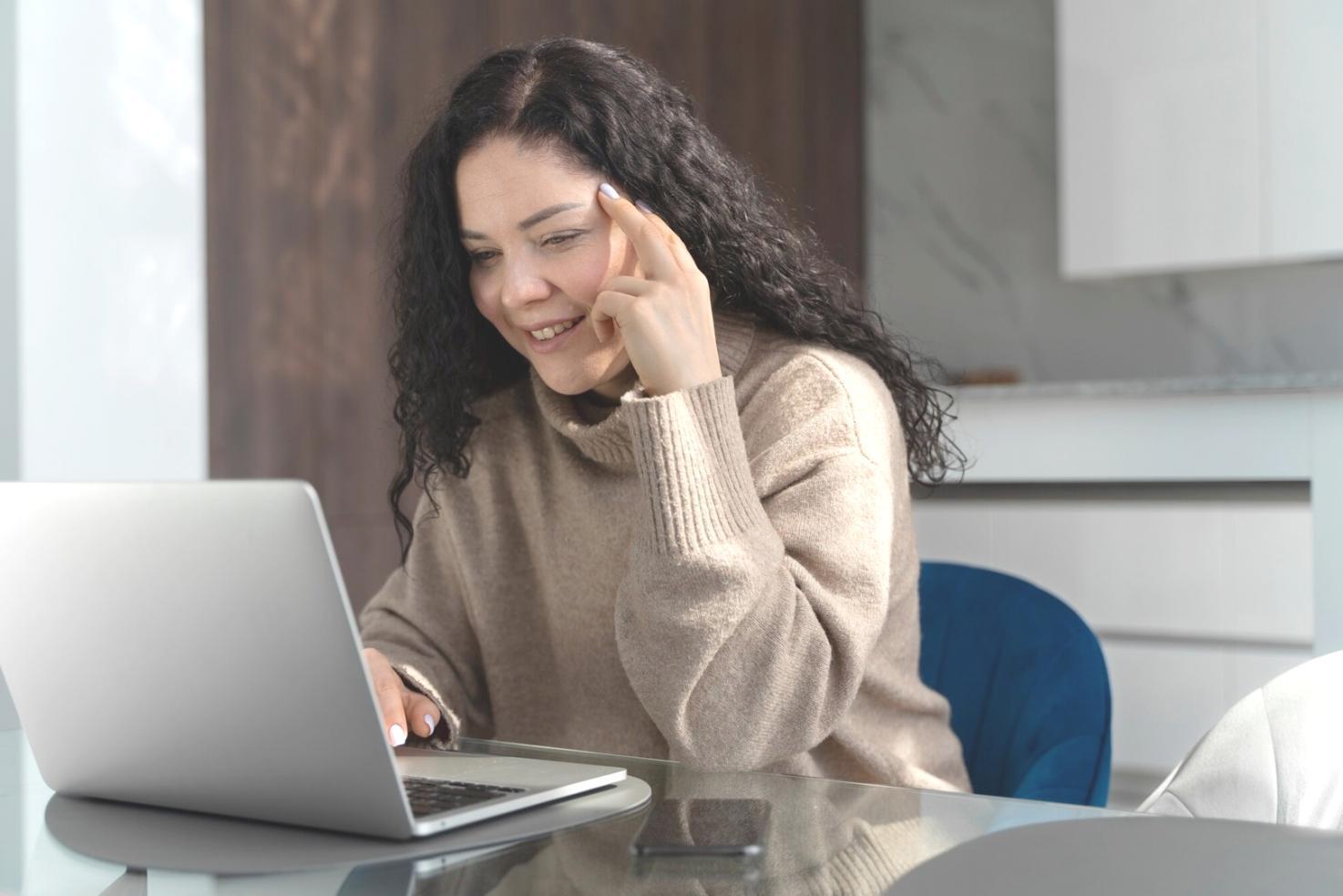 Classroom setting with students learning financial concepts on laptops